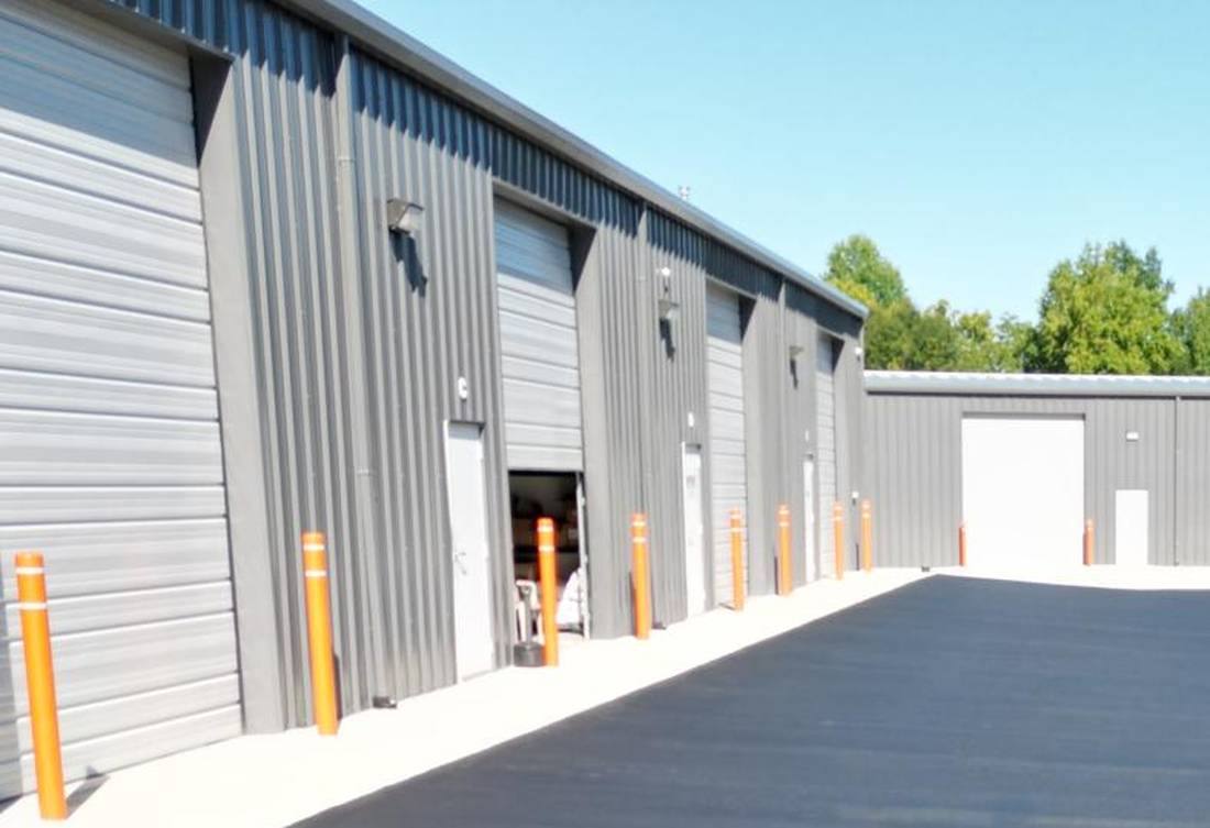 Open roll-up bay door with a tenant working inside