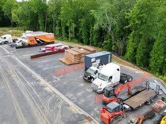 Aerial view of the gravel yard with trucks, trailers and equipment parked in marked spaces